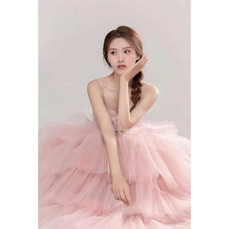 A soft pink tulle wedding photography dress with multi-layered skirt strapless bodice and delicate lace detailing
