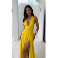 A vibrant yellow halter-neck maxi dress with a deep v-back and high slit shown from the back for a summer look