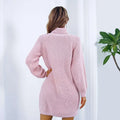 A soft pink winter turtleneck sweater dress with long ribbed knit sleeves and a black belt detail