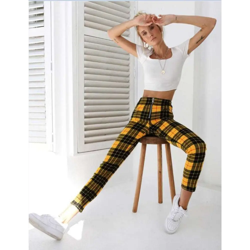 Yellow and black plaid women’s high-waist stretch leggings with a front zipper detail for stylish comfort