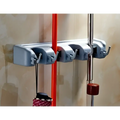 Gray plastic mop hook wall hanging organizer rack with four hooks holding a red-handled brush and silver rod
