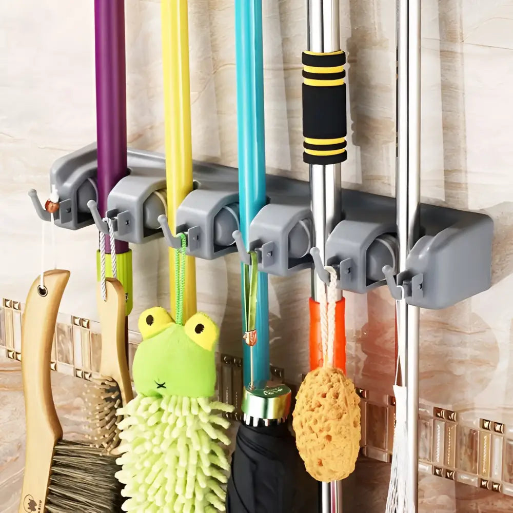 Gray plastic mop hook wall organizer rack with multiple hooks holding colorful cleaning tools on wall hanging organizer
