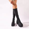 Black platform knee high elastic leather boots with sleek stretchy material and bold chunky soles for stylish wear