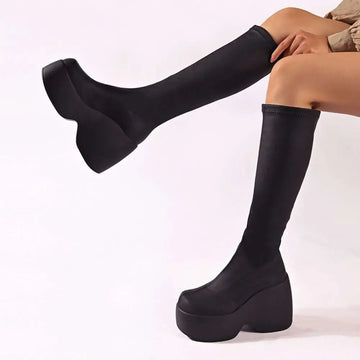 Black platform knee high elastic leather boots with sleek stretchy upper and thick chunky sole for stylish wear