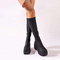 Black platform knee high elastic leather boots with sleek stretchy material and bold chunky soles for stylish wear