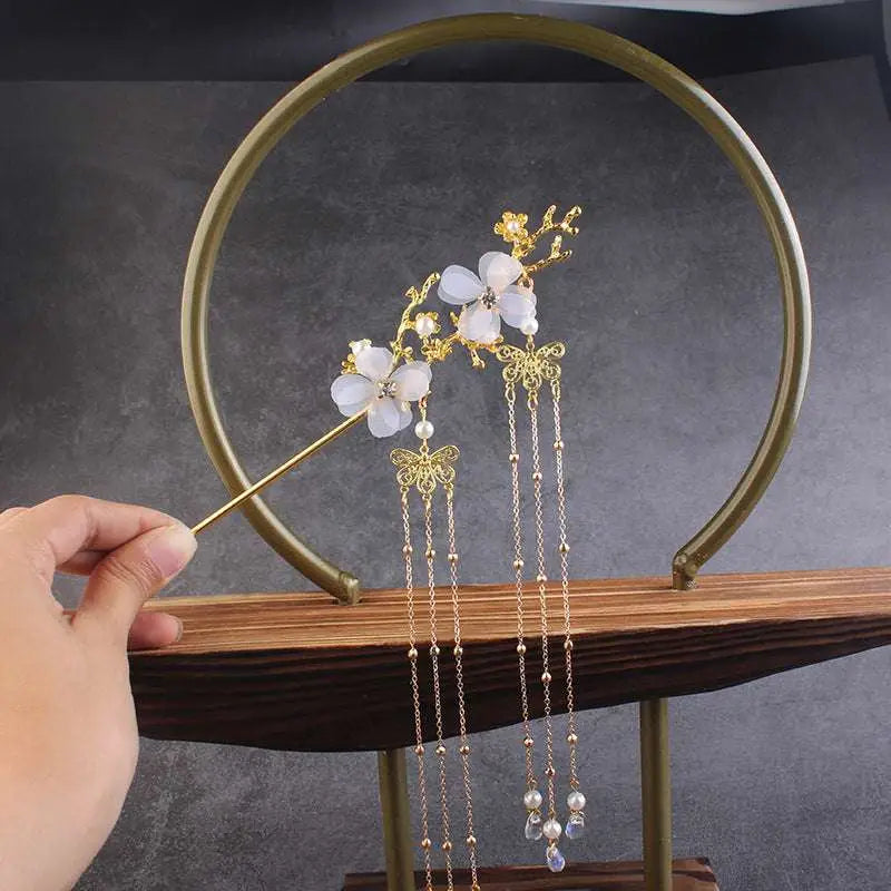 A delicate gold-toned ancient style hairpin with plum blossom charms and pearl bead chains for hair accessories hanfu