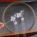 Silver plum blossom ancient style hairpin with delicate white floral embellishments and butterfly chain accents for hanfu hair accessories