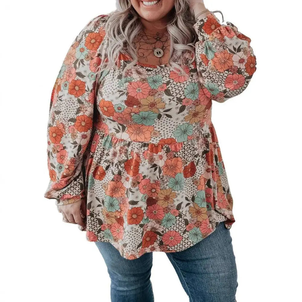 Plus size casual loose floral chiffon peplum shirt with long sleeves and vibrant orange teal brown floral pattern on off-white