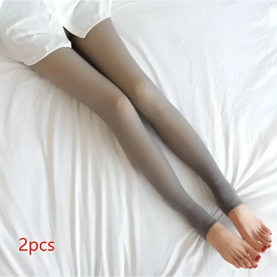 A pair of plus size fake translucent fleece lined tights in dark gray with sheer, smooth, stretchy material and snug fit