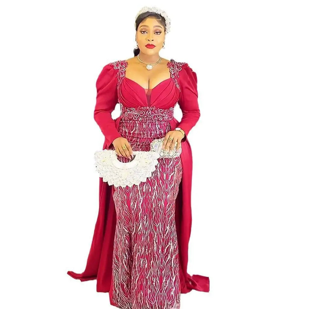 White lace clutch with scalloped edges and handle accompanying a vibrant red plus size long sleeved sequined evening dress