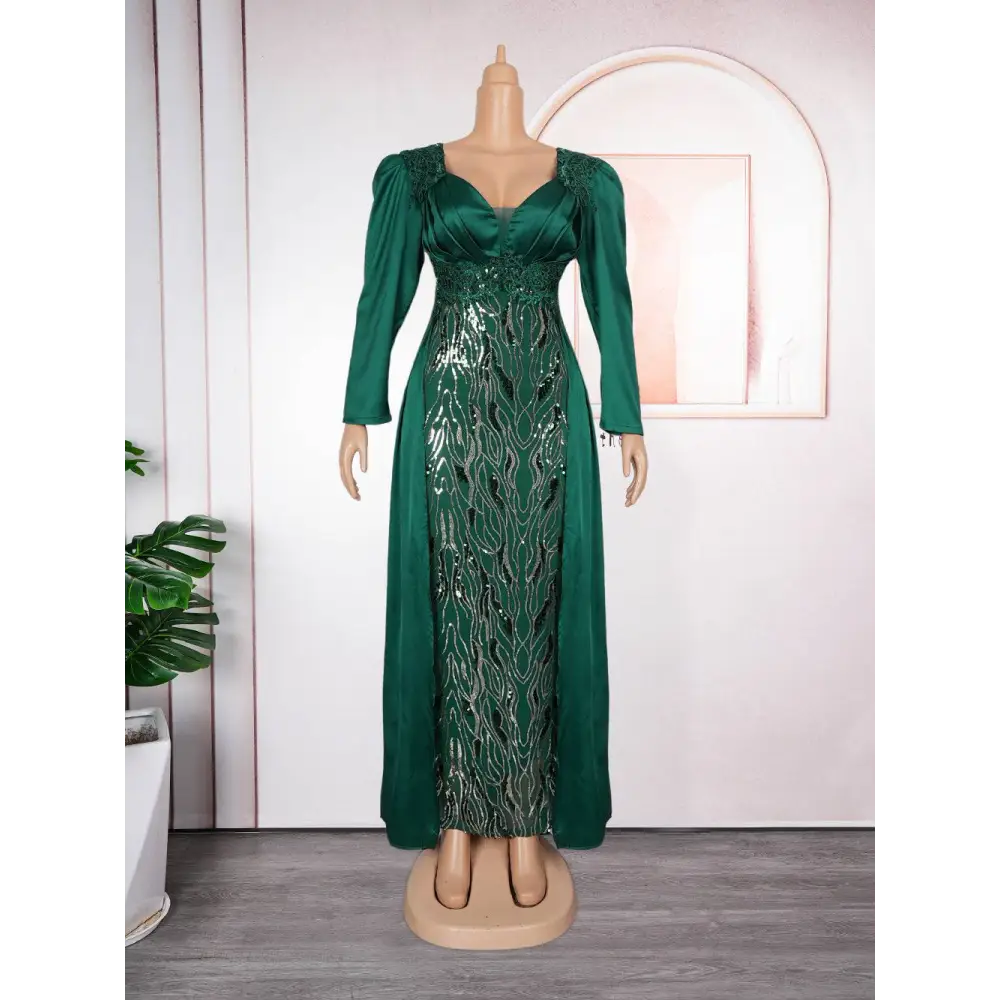 Plus size long sleeve sequined evening dress in emerald green satin with flowing pattern on the bodice