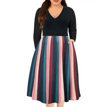 A plus size dress with a black long-sleeved striped v neck top and a flared fall dress skirt in pink teal and maroon
