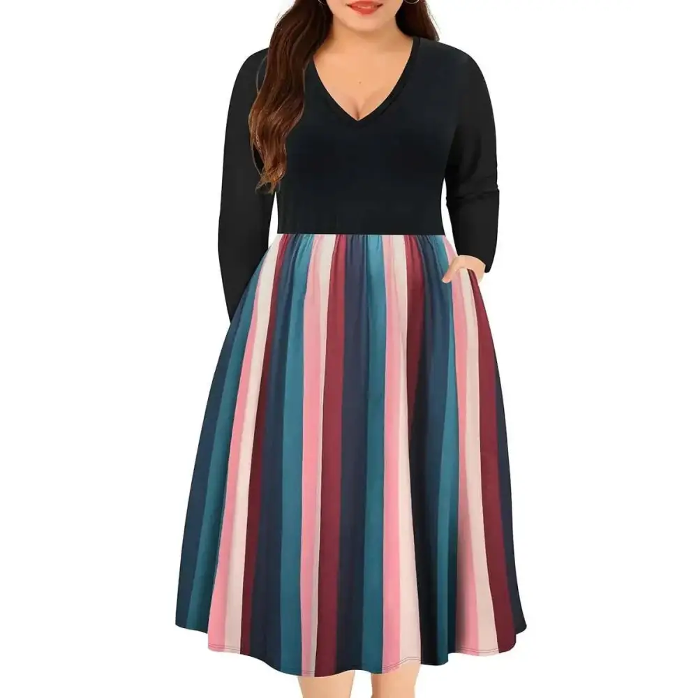 A plus size dress featuring a striped v neck and long sleeves in black with a flared fall skirt in pink, teal, and maroon
