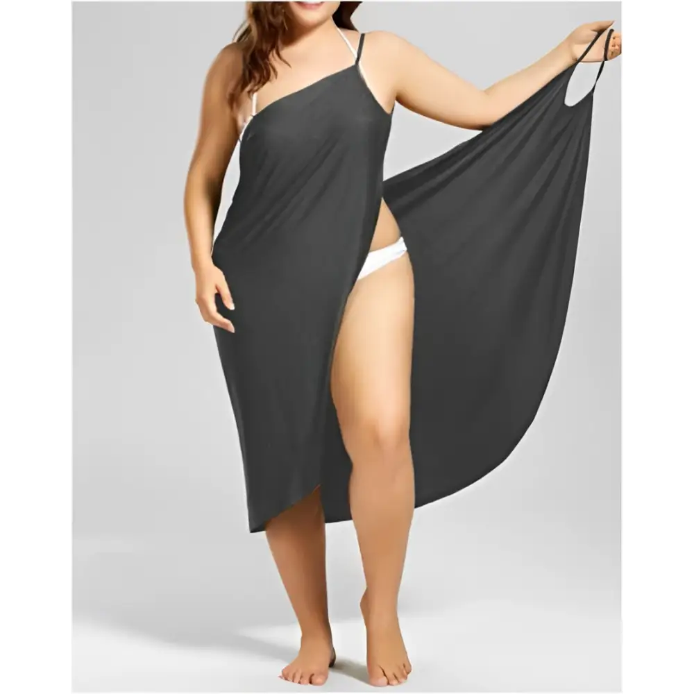 Black plus size suspenders beach skirt one shoulder cover up with flowing fabric, thin straps, and high slit