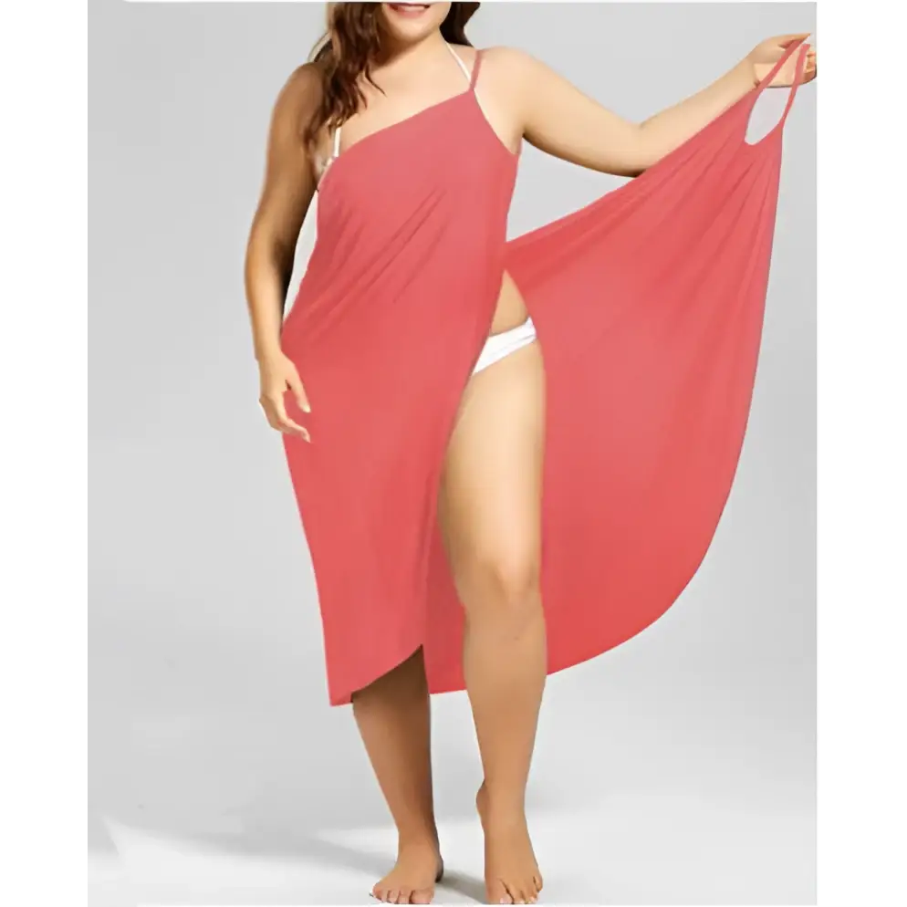 A flowing coral plus size suspenders beach skirt cover up with thin straps and a high slit for shoulder cover