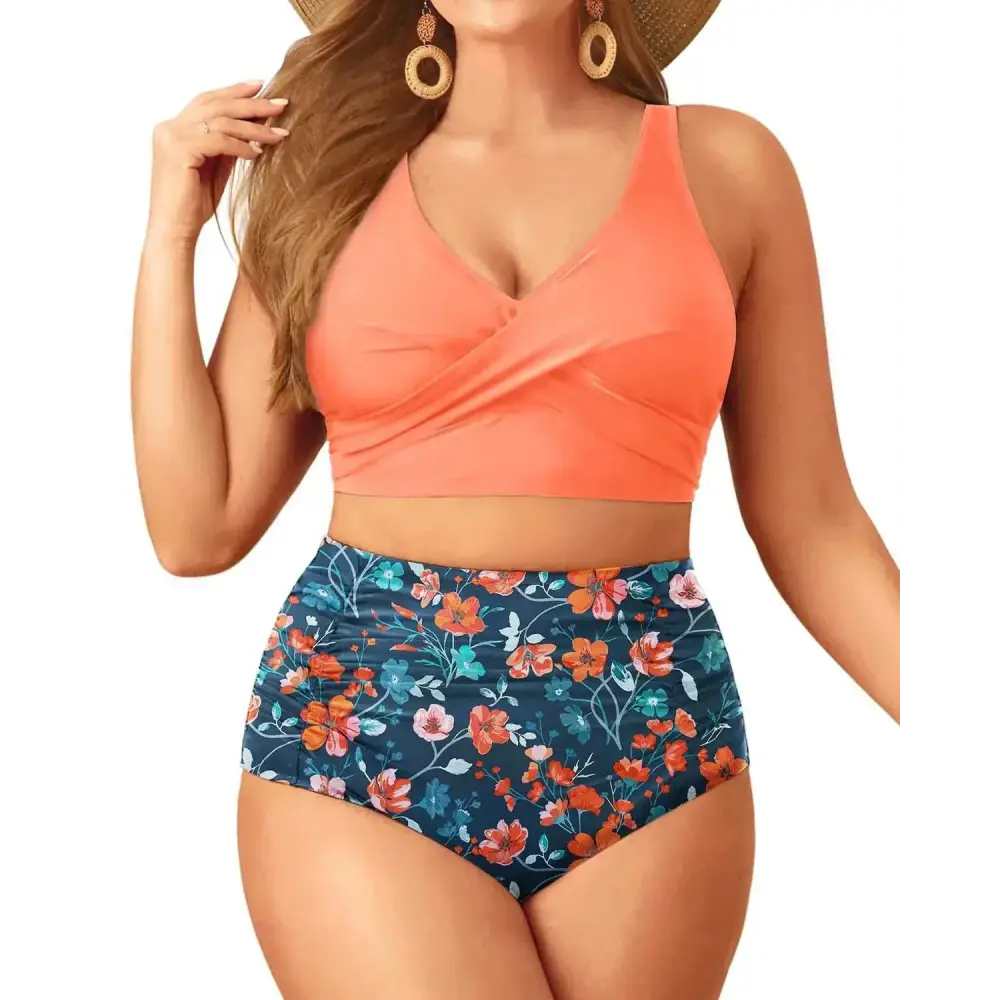 Plus size tummy control floral bathing suit with coral cross-front tank top and navy blue orange peach floral shorts