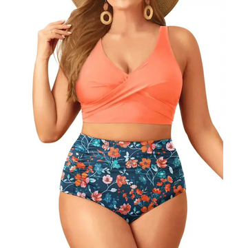 Plus size tummy control floral bathing suit with coral cross-front tank top and navy blue orange peach floral shorts