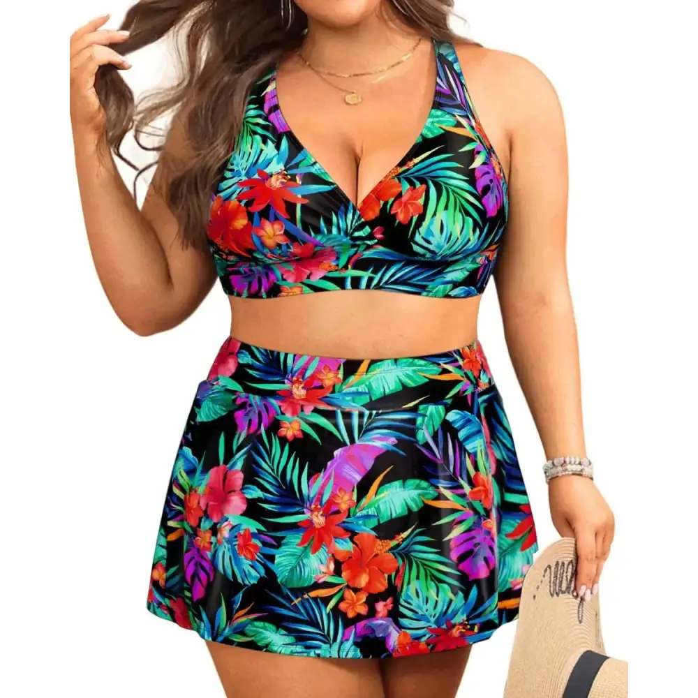 Plus size tummy control bathing suit two-piece with vibrant red green and purple tropical floral print on black base