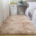 A plush gray shaggy carpet floor mat with soft fluffy texture and beige tones lies on the floor