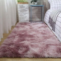 A plush gray shaggy carpet floor mat with a soft gradient pink shag texture and subtle color variation