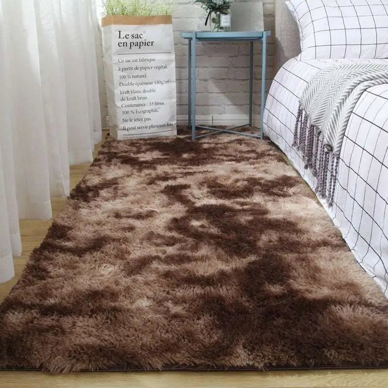 A plush gray shaggy carpet floor mat with long soft fibers and a gradient of darker to lighter brown shades