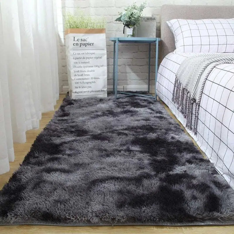 Plush gray shaggy carpet floor mat with soft fluffy texture and gradient tones from dark charcoal to light gray