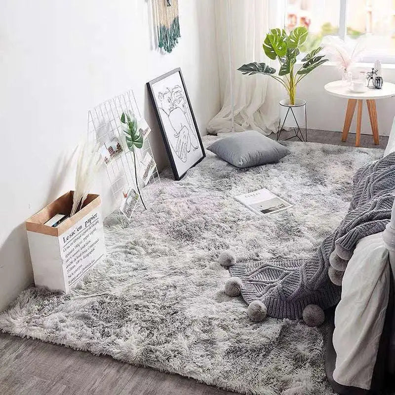 A plush gray shaggy carpet floor mat with soft fluffy texture and subtle shade variations for cozy interiors