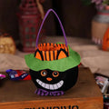 Plush pumpkin halloween candy bag in black with smiling face, green witch hat, orange-striped brim, and purple handle for party favour bags