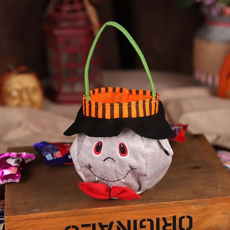 Gray plush pumpkin halloween candy bag shaped like a ghost with black hat, orange-striped rim, and red bow tie party favour bag