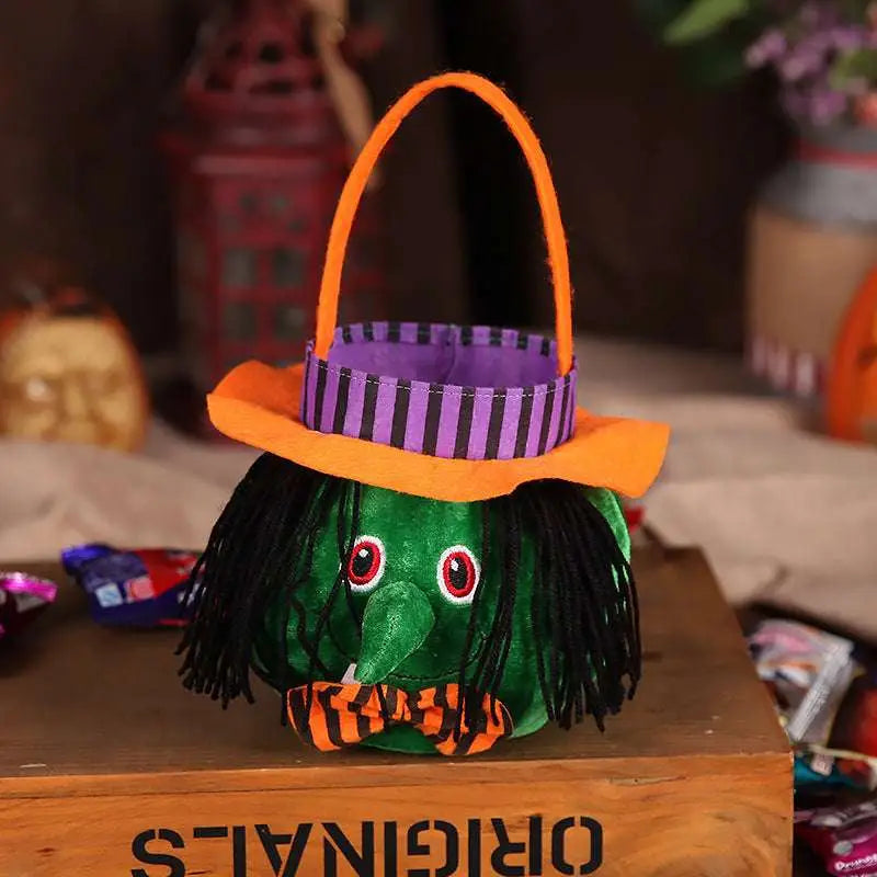 Plush pumpkin halloween candy bags feature a green witch design with an orange hat black yarn hair and red eyes for party favour bags