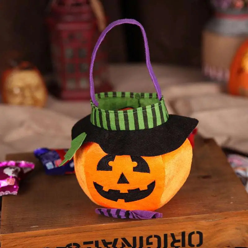 Plush pumpkin halloween candy bag in orange with black witch hat purple handle and green striped brim for party favour bags