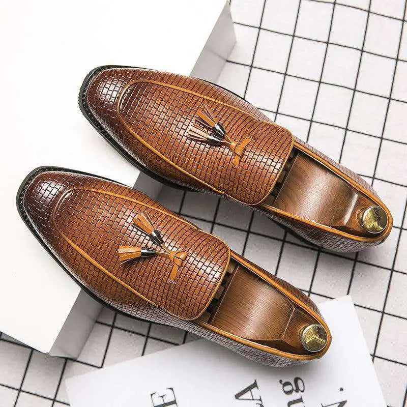 Brown pointed men’s slip woven leather shoes with tassels and gold-toned metal accents for formal wear