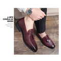Pointed men’s slip on burgundy woven leather shoes with tassels featuring a rich textured design