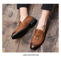 Brown pointed men’s slip on woven leather shoes with tassel detail and black rubber soles for stylish wear