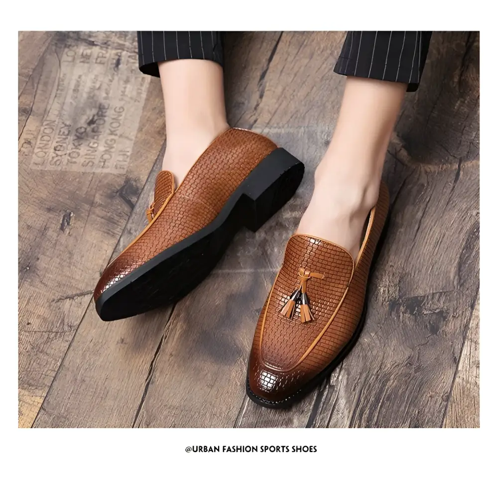 Brown pointed men’s slip on woven leather shoes with tassel detail and black rubber soles for stylish wear