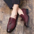 Burgundy pointed men’s slip on woven leather shoes with tassel details in a slip woven leather design