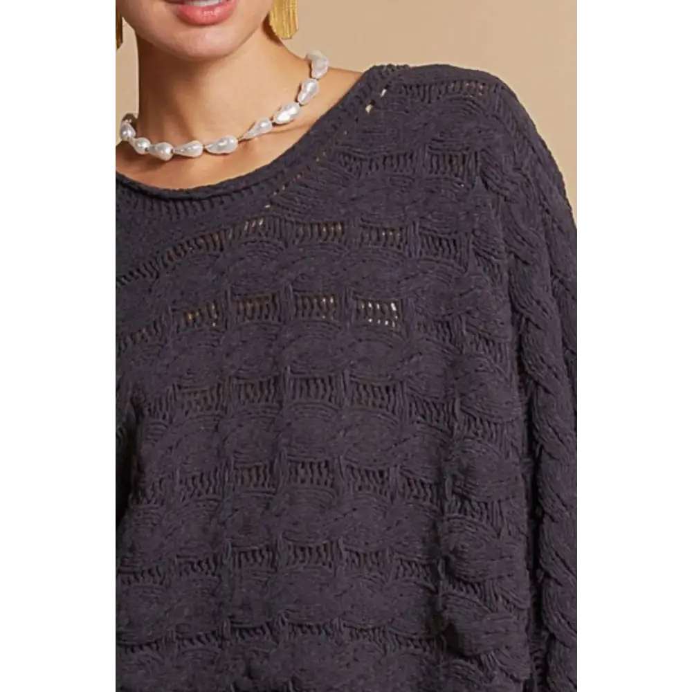 Dark gray cable knit cropped sweater with scalloped neckline and intricate textured knit pattern