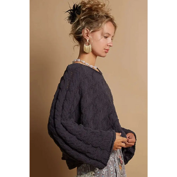 Dark navy cable knit cropped sweater with oversized loose fit and textured pattern in knit cropped sweater style