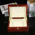Polished reddish brown wooden watch box custom with gold hardware and cream-colored interior for jewelry storage