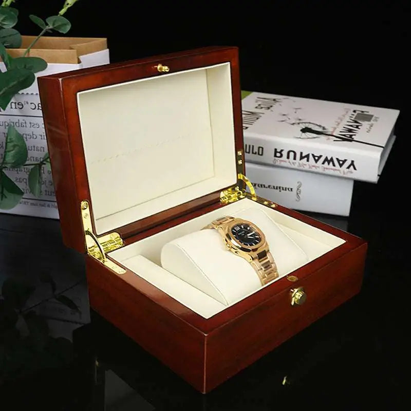 Gold-tone watch with black dial in a polished reddish brown watch box custom jewelry case for elegant storage