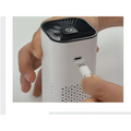 White cylindrical portable car air purifier with black top featuring power button and usb-c negative ion generator port
