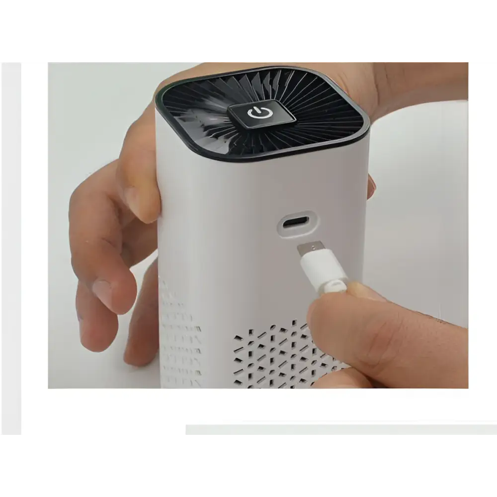 White cylindrical portable car air purifier with black top featuring power button and usb-c negative ion generator port