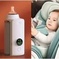 White portable constant temperature baby bottle warmer with usb charging and green display showing 42 degrees