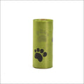 A roll of lime green plastic dog poop bags with black paw prints for a portable poop bag dispenser