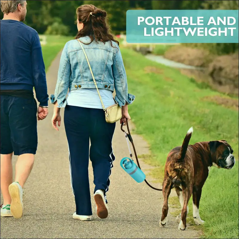 Light blue portable dog poop scooper with handle and leash attachment includes a poop bag dispenser for convenience