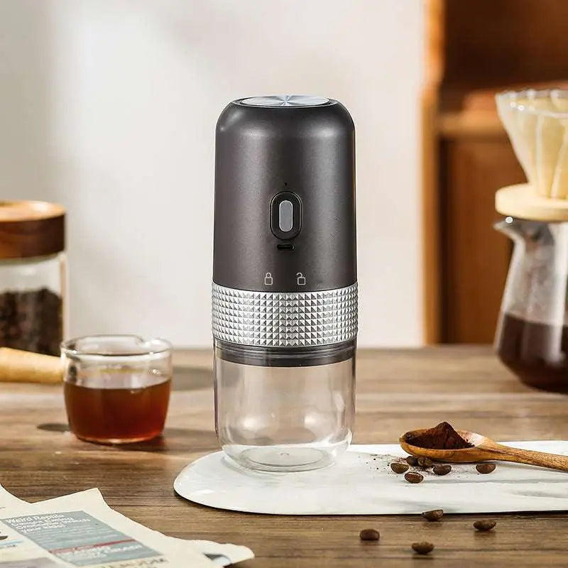 Black and silver portable electric ceramic coffee grinder with usb charging capability and textured metallic band grip