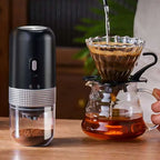 Black and silver portable electric ceramic coffee grinder with usb charging capability and textured metallic band detail