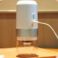 Portable electric ceramic coffee grinder in white and silver with usb charging capability and textured metallic band