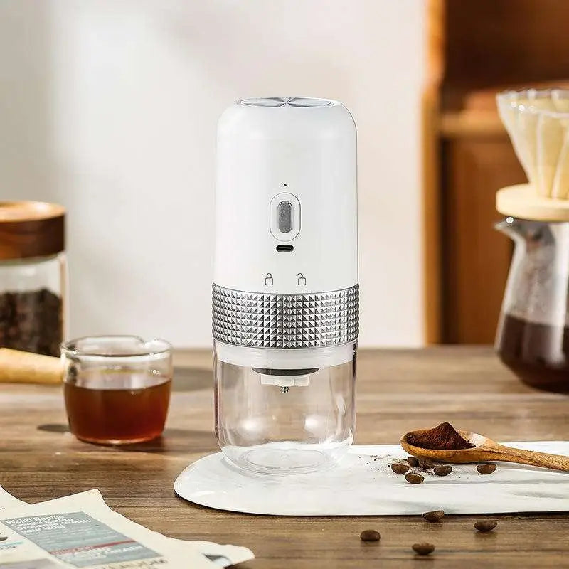 White and silver portable electric ceramic coffee grinder with usb charging capability textured metallic band and glass base