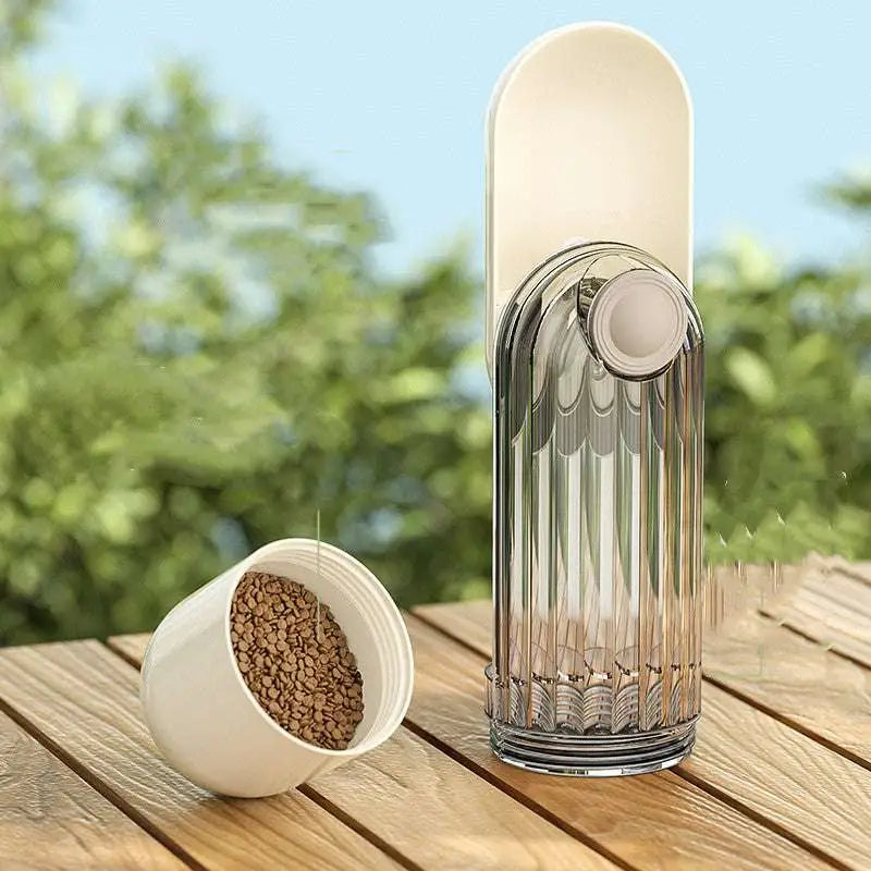 Transparent glass coffee grinder with ribbed design and off-white lid alongside portable green dog walking pet water cup